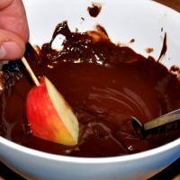 Melt chocolate and coat the pieces of one apple